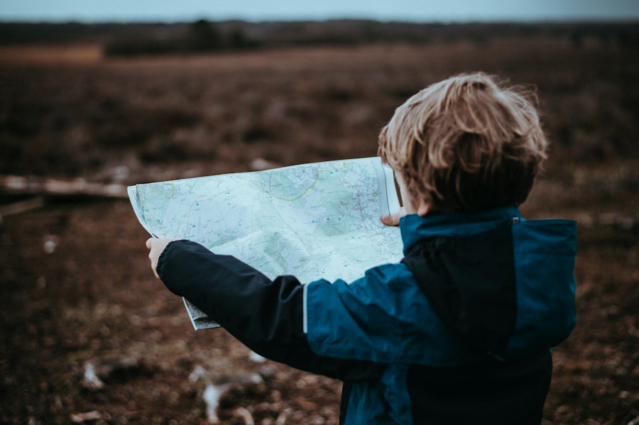 Child reading a treasure map outdoors